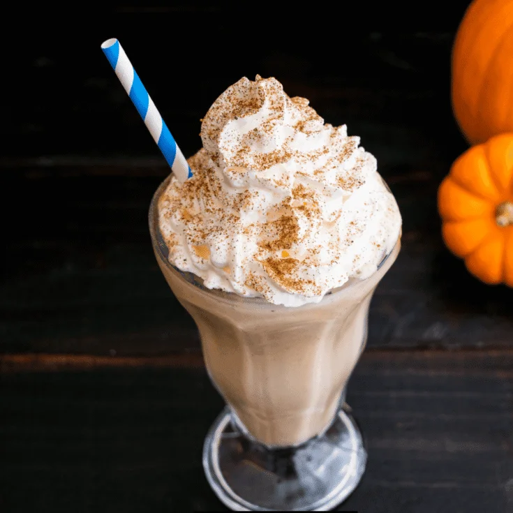 Homemade pumpkin milkshake with whipped cream on top