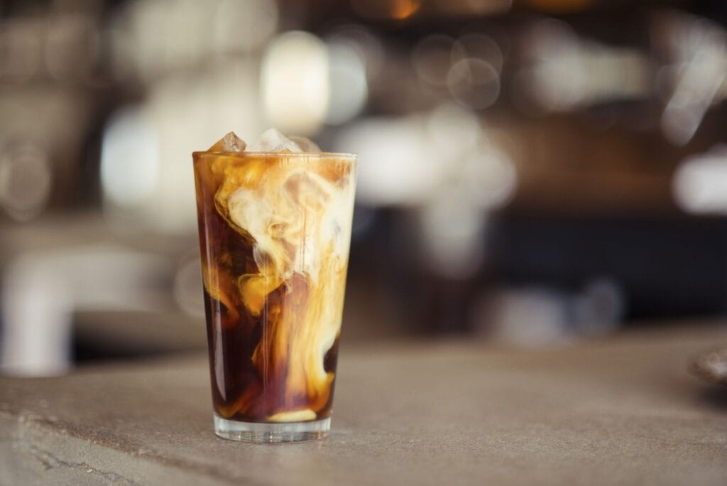 Campout Cold Brew (Dutch Bros-Inspired) in a glass with milk swirling in