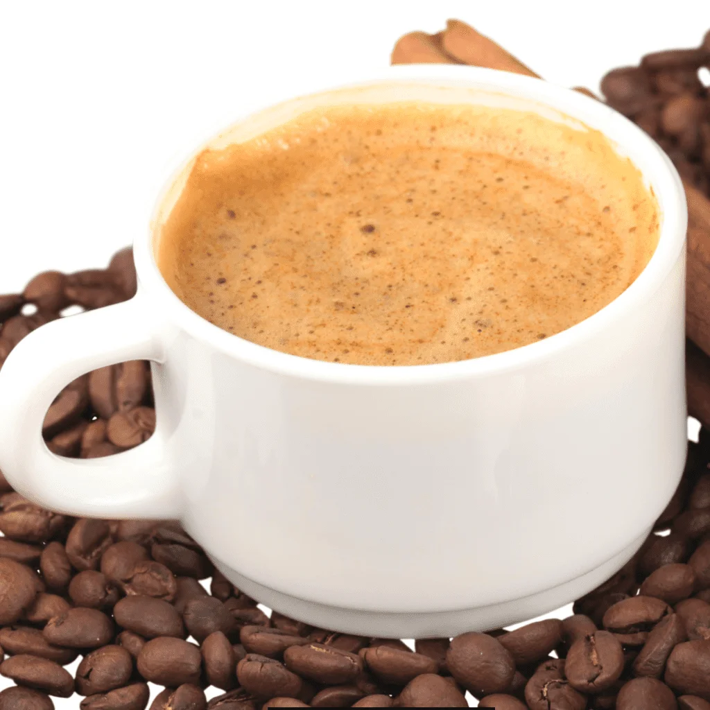 Warm Copycat Dunkin' Almond Spice Coffee served in a pile of coffee beans